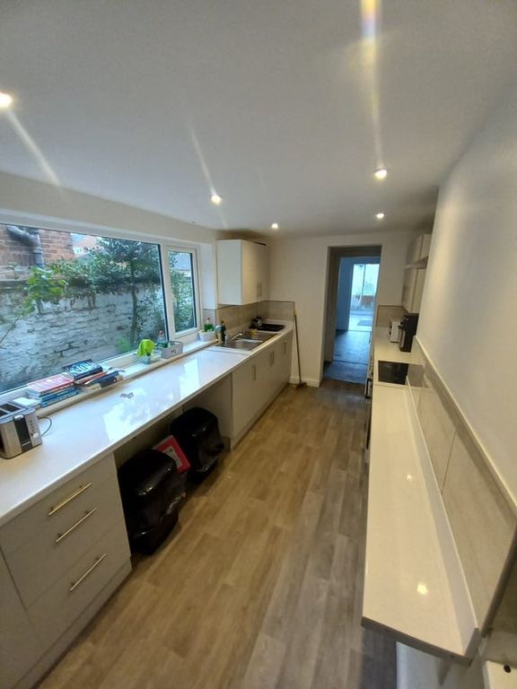 Property photo 2 of 5 Bright And Modern Kitchen Featuring Sleek White Co...
