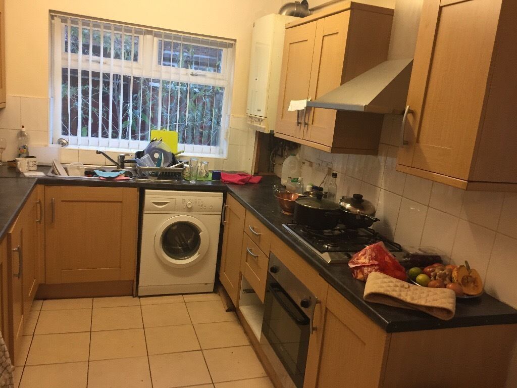 Property photo 3 of 4 Bright Galley-Style Kitchen With Light Wood Cabine...