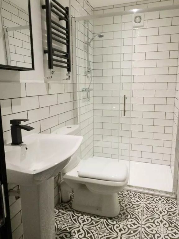 Property photo 1 of 9 A Fresh And Modern Bathroom Featuring Stylish Patt...