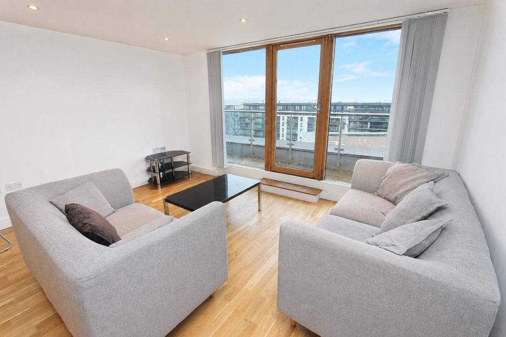 Property photo 1 of 9 Bright Lounge With Balcony Access And Sleek Sofas...