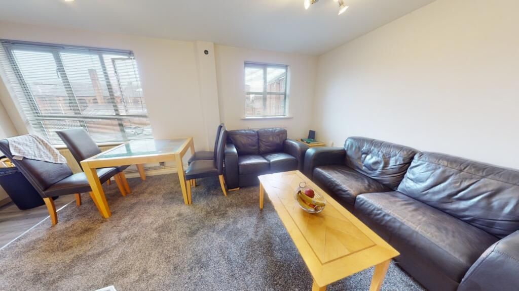 Property photo 2 of 6 A Bright And Inviting Living Room Featuring Comfor...
