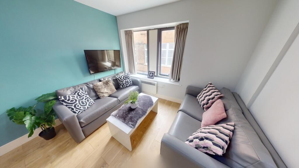 Property photo 3 of 7 Bright And Cozy Living Room Featuring Two Comforta...