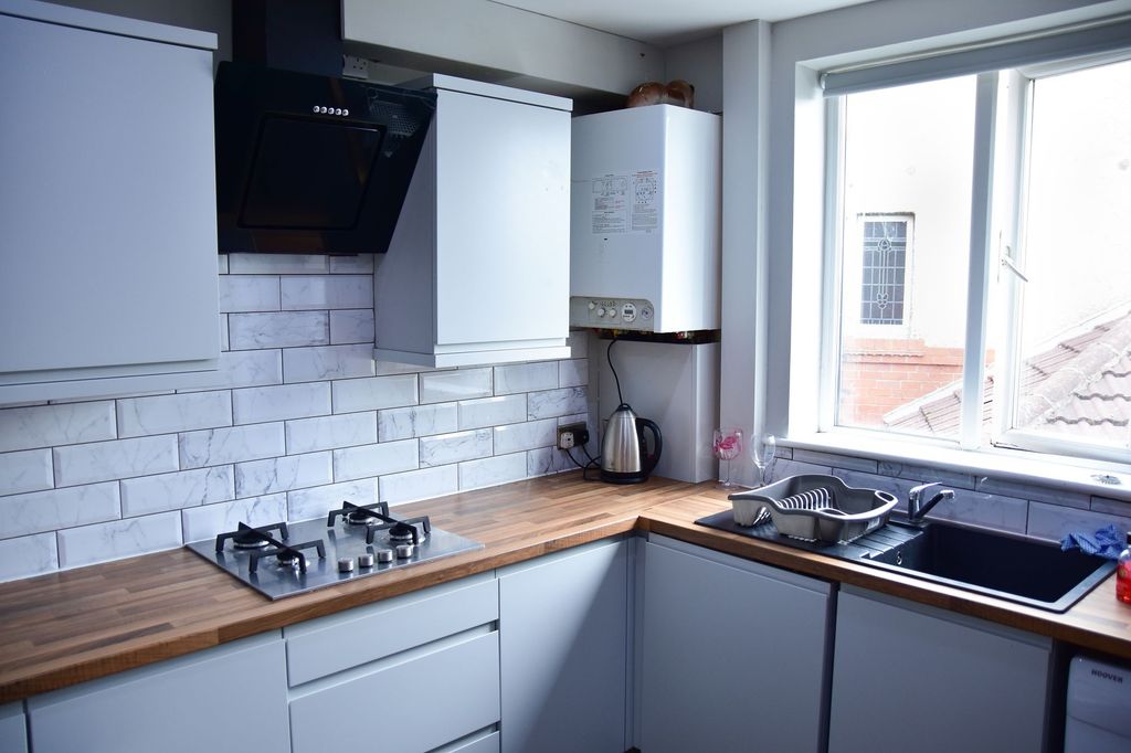 Property photo 3 of 9 Bright And Modern Kitchen With Sleek White Cabinet...