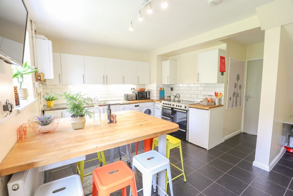 Property photo 1 of 6 Bright And Modern Kitchen Featuring Ample White Ca...