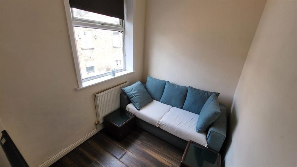 Property photo 1 of 12 Bright And Inviting Living Room Featuring A Comfor...