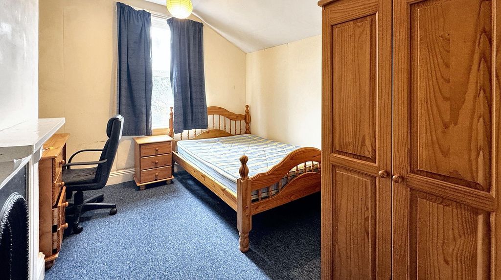 Property photo 1 of 5 A Cozy, Well-Maintained Bedroom Featuring A Wooden...