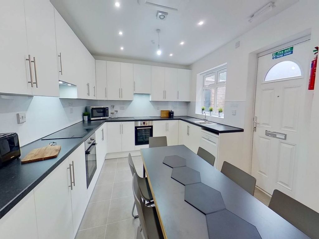 Property photo 2 of 8 Bright And Modern Kitchen Featuring Ample White Ca...