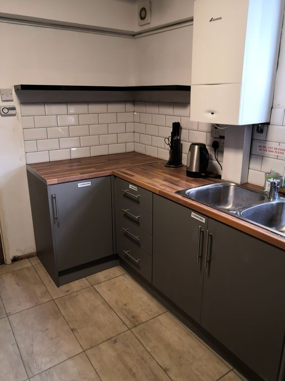 Property photo 2 of 10 A Modern Kitchenette Featuring Sleek Cabinetry And...