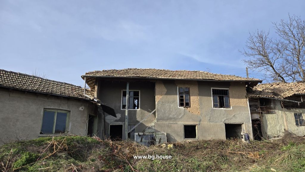 Property photo 1 of 54 Exterior View Of An Old Bulgarian House With Tiled Roof And Several Windows, Showing The Rustic Facade And Surrounding Dry Vegetation.