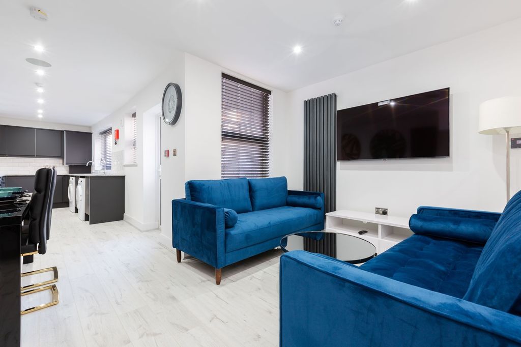 Property photo 1 of 4 Modern And Spacious Living Room Featuring Vibrant ...