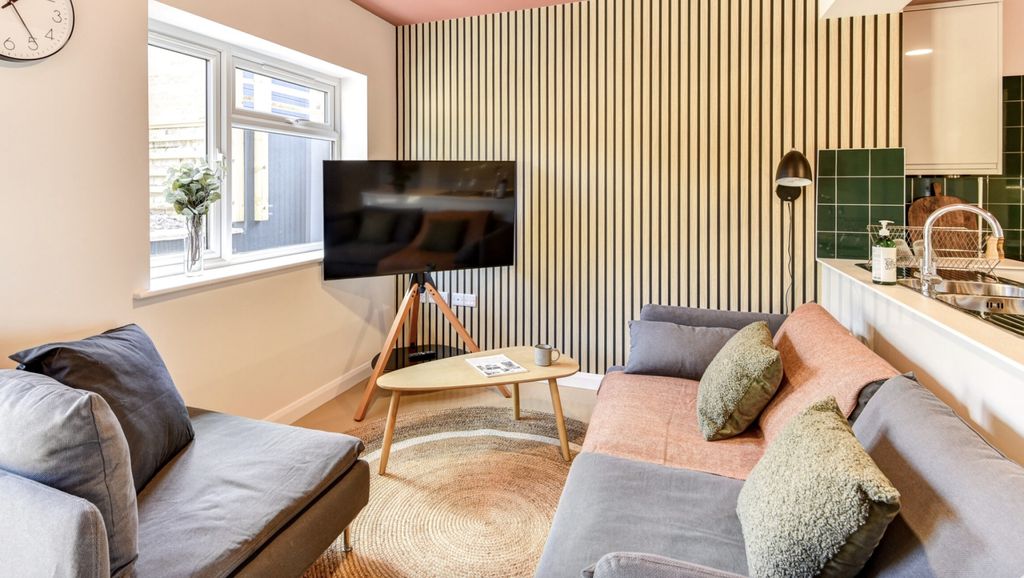 Property photo 3 of 5 Experience A Cozy And Stylish Living Room Featurin...
