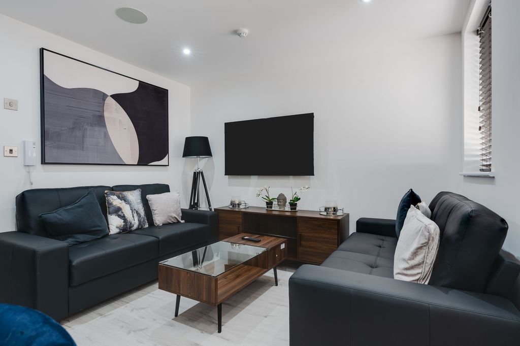 Property photo 2 of 12 Modern And Inviting Living Room Featuring Sleek Bl...