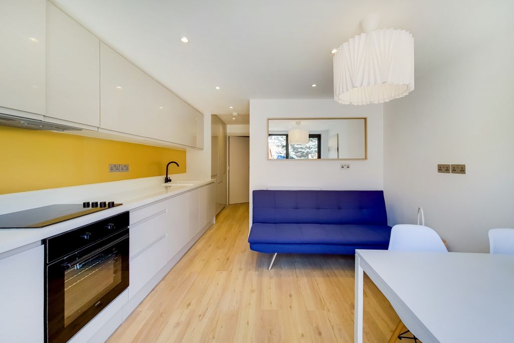 Property photo 2 of 7 Bright And Modern Living Room Featuring A Vibrant ...