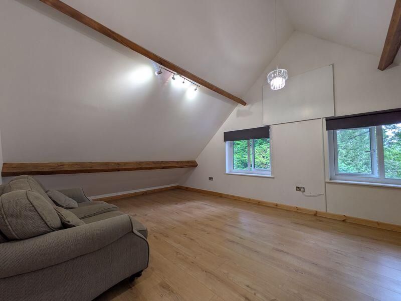 Property photo 1 of 12 A Bright And Airy Living Room Featuring High Vault...