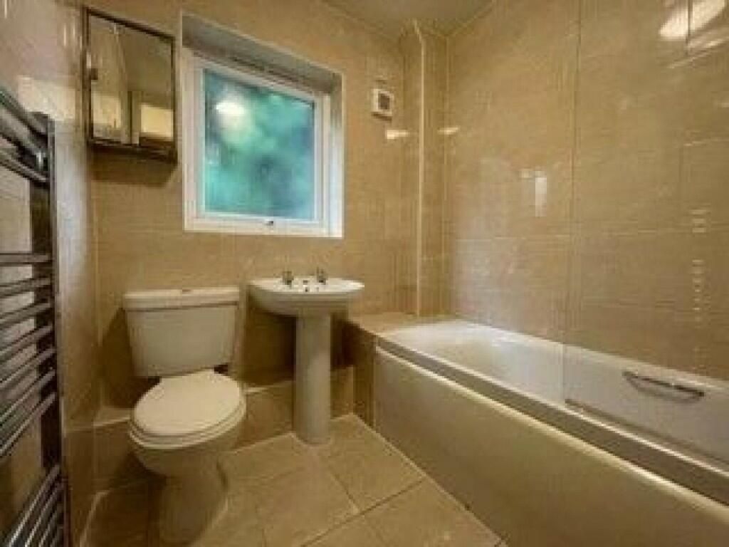 Property photo 1 of 8 A Well-Maintained Bathroom Featuring A Modern Whit...