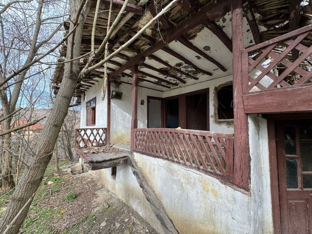 Property photo 3 of 11 Close-Up Showing Wooden Balcony With Peeling Paint And Entrance Door Of The Old House Surrounded By Leafless Trees.