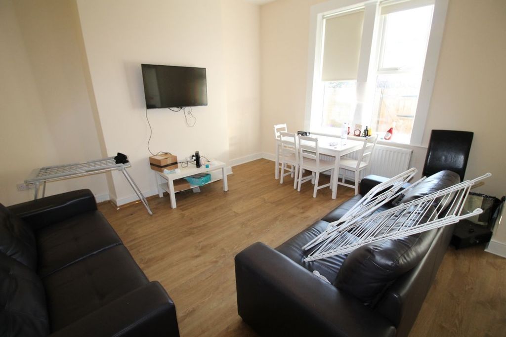 Property photo 3 of 15 A Bright And Spacious Living Room Featuring Modern...