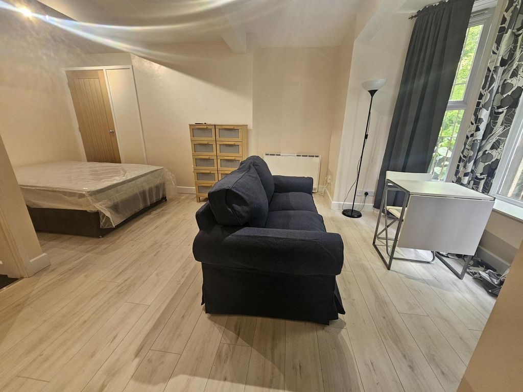 Property photo 1 of 6 Spacious And Well-Lit Bedroom Featuring A Comforta...