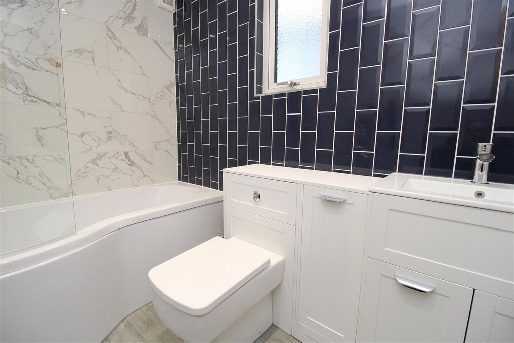 Property photo 2 of 20 Elegant Bathroom With Marble And Navy Tiling...