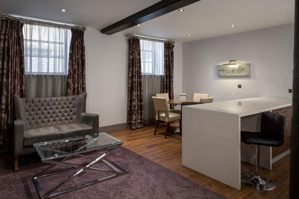 Property photo 2 of 4 Elegant Living Space With Breakfast Bar And Sofa...