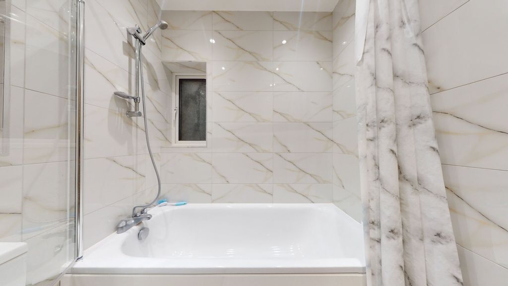 Property photo 1 of 7 Bright, Modern Bathroom With A Full Bathtub And Ov...