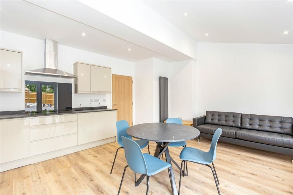 Property photo 1 of 15 Bright And Modern Living Room Featuring A Sleek Op...