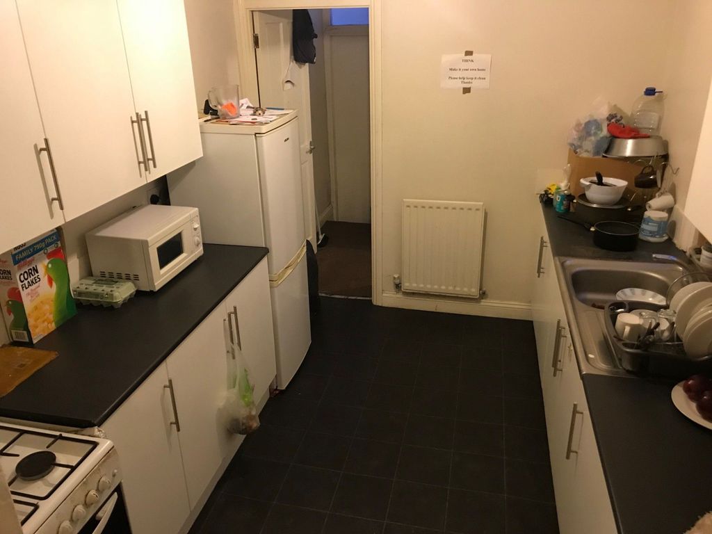 Property photo 3 of 4 A Compact, Functional Kitchen With White Cabinets ...