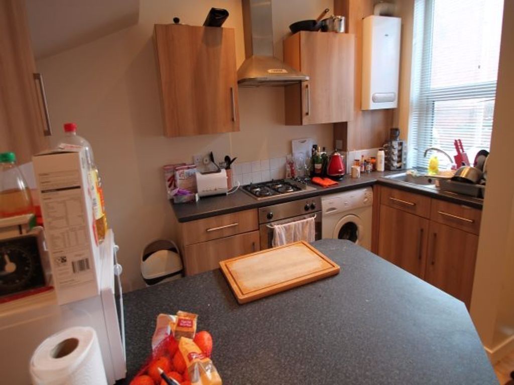 Property photo 3 of 7 A Cozy, Well-Equipped Kitchen Featuring Wooden Cab...