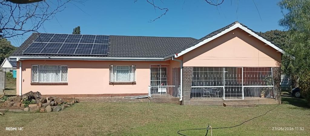Property photo 1 of 25 Single-Story Peach House With Solar Panels On The Roof, Two Barred Windows, And A Large Gated Carport On The Right, Set In A Green Yard.