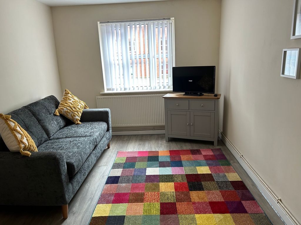 Property photo 3 of 13 A Cozy Living Room Featuring A Comfortable Sofa, v...