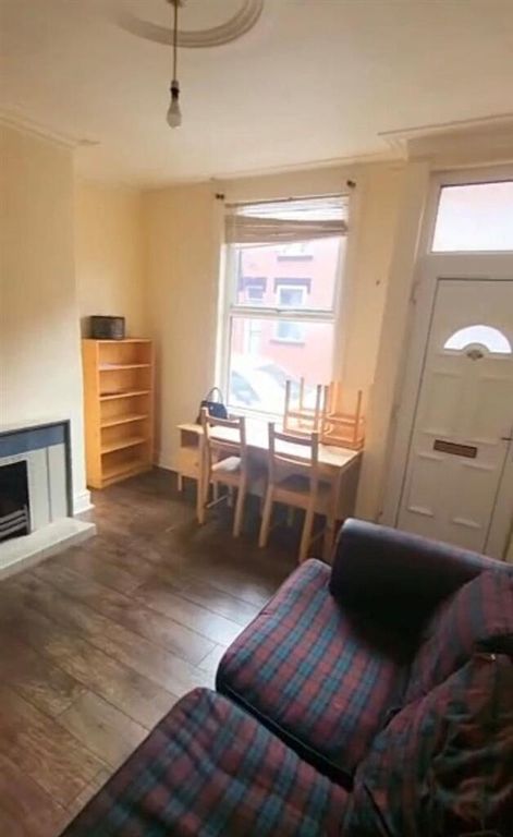 Property photo 3 of 9 A Cozy Living Room Featuring A Fireplace, Wooden F...