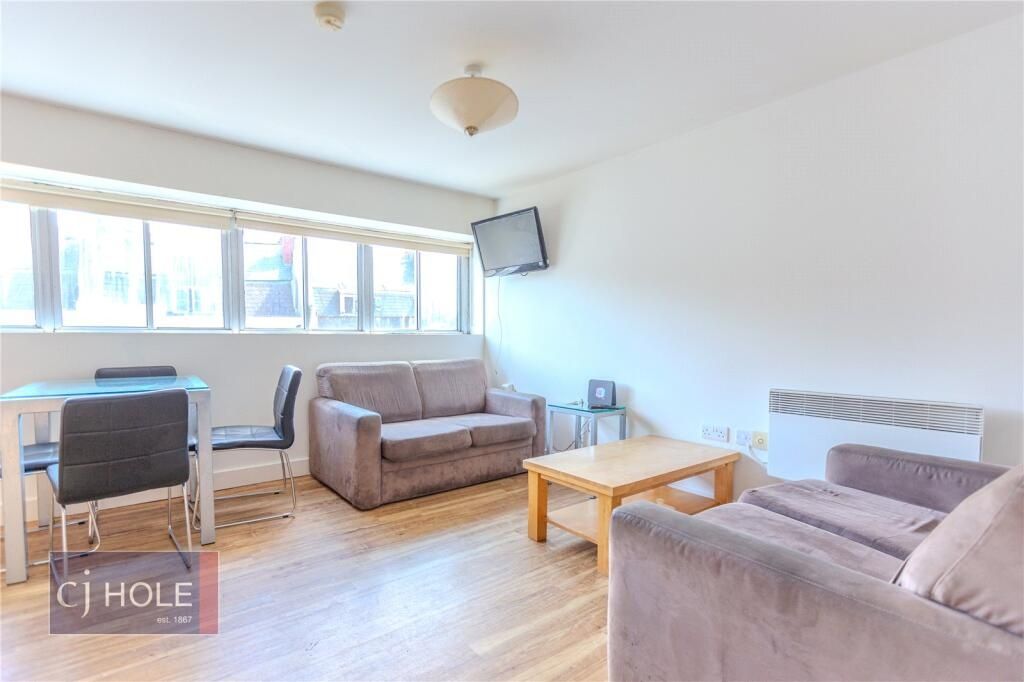 Property photo 2 of 12 Bright And Airy Living Room Featuring Large Window...