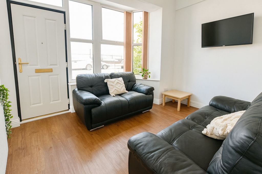 Property photo 2 of 8 Bright And Tidy Living Room Featuring Modern Black...