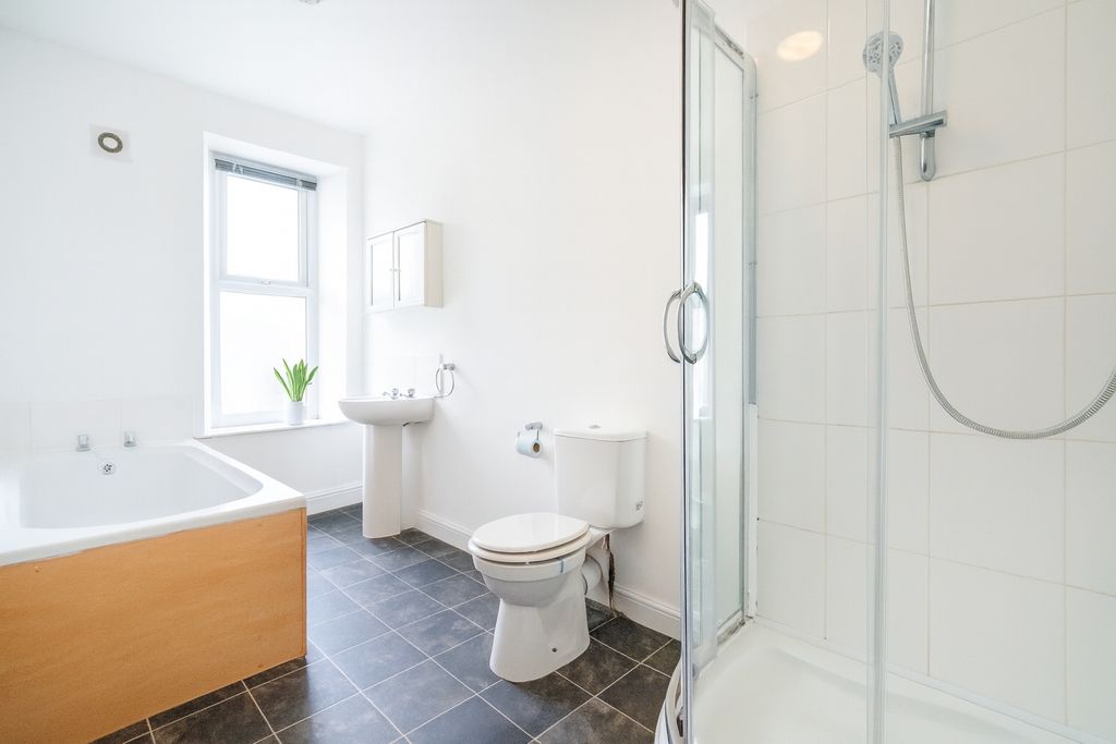 Property photo 3 of 6 Bright And Modern Bathroom Featuring A Large Batht...