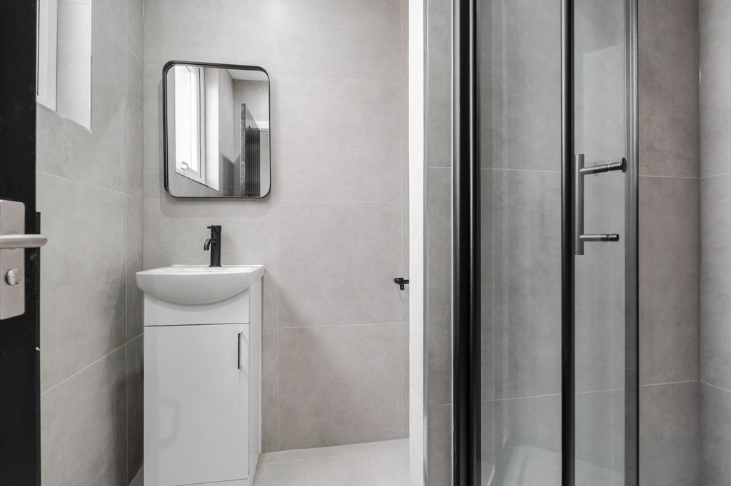 Property photo 1 of 16 Modern And Clean Bathroom With A Compact White Sin...
