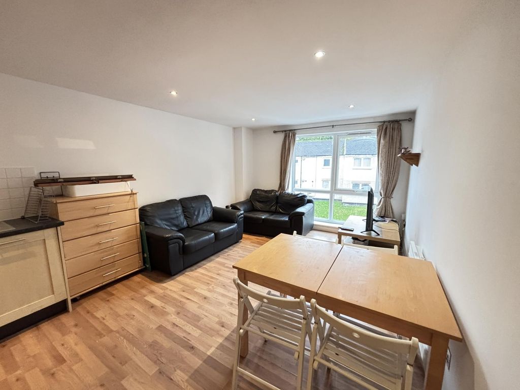 Property photo 2 of 17 A Spacious And Well-Lit Living Room With Modern Fu...