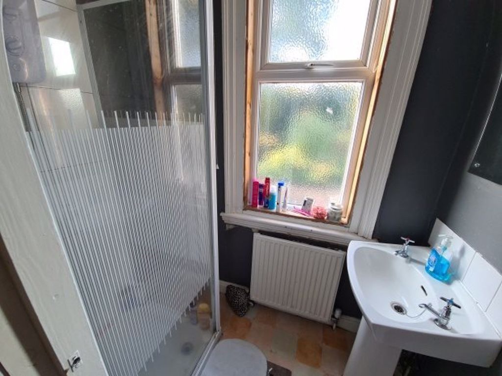 Property photo 2 of 26 A Compact Bathroom Featuring A Glass-Enclosed Show...