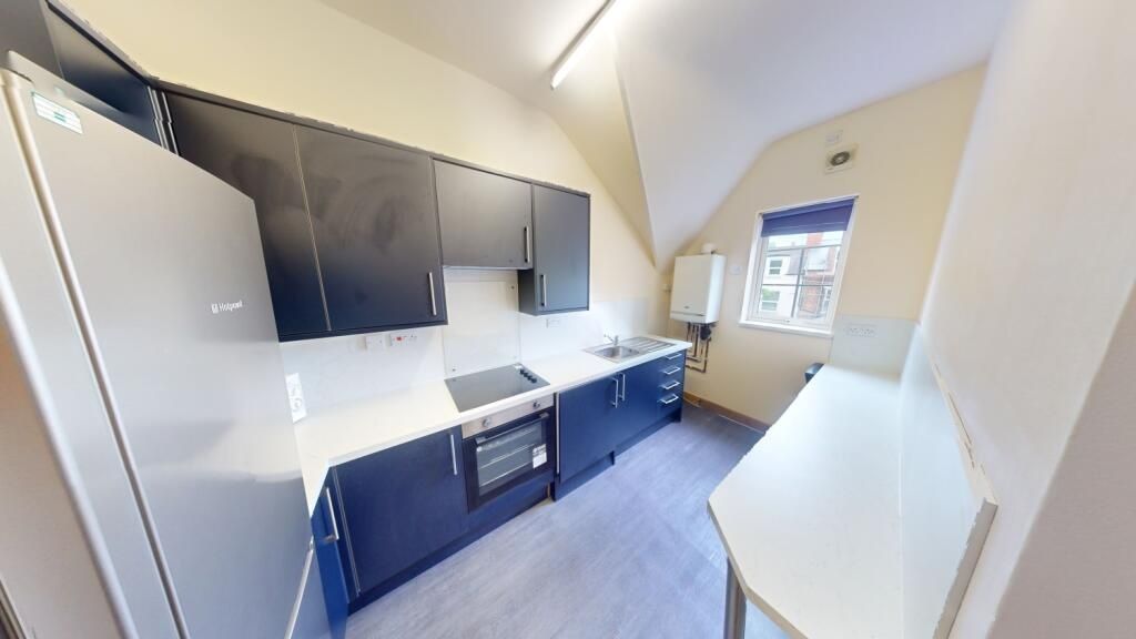 Property photo 2 of 9 Bright And Modern Kitchen Featuring Sleek Cabinetr...