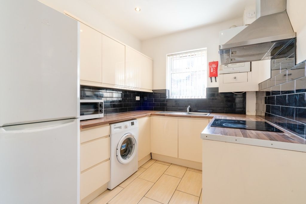 Property photo 2 of 10 Bright And Clean Kitchen Featuring White Cabinets,...