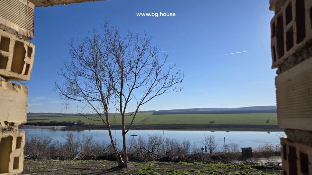 Property photo 2 of 36 Lake And Countryside View With A Leafless Tree Visible Through An Opening In The Unfinished Brick Walls.