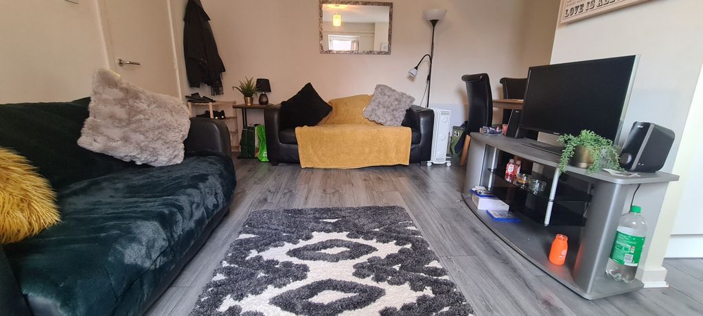 Property photo 2 of 8 A Contemporary Living Room Featuring A Dark Velvet...