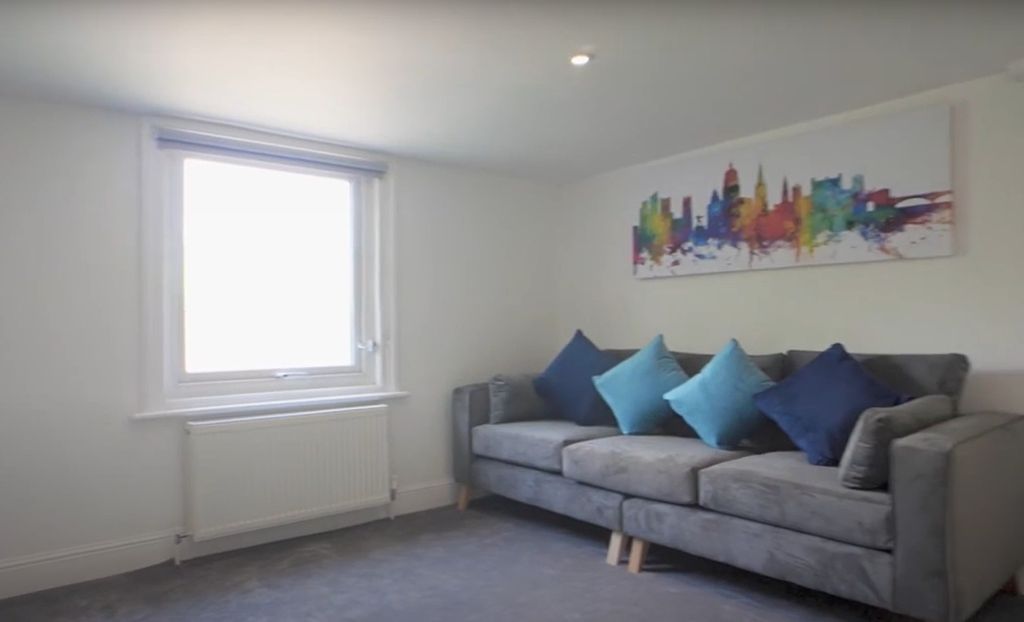 Property photo 2 of 5 Bright And Inviting Living Room Featuring A Comfor...