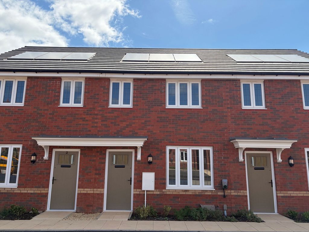Property photo 1 of 9 Two Identical Brick Townhouses With Gray Doors And White-Framed Windows Stand Under A Bright Blue Sk