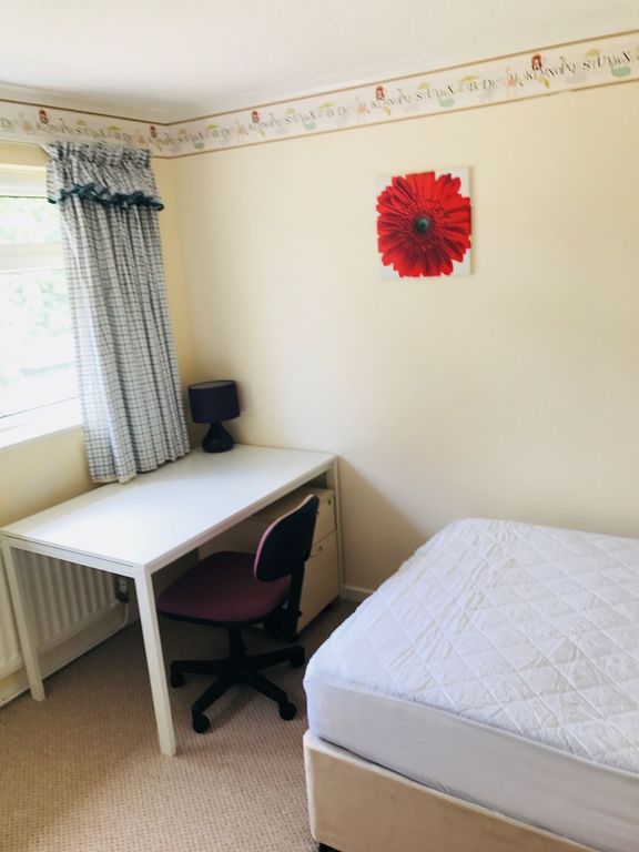 Property photo 1 of 5 A Cozy Bedroom Featuring A Single Bed, A Desk With...