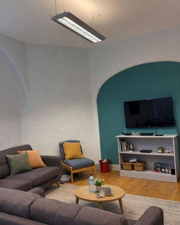 Property photo 2 of 10 Cosy Lounge Area With A Feature Wall And Smart TV...