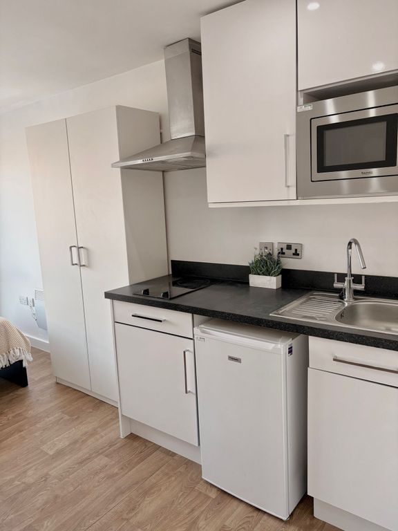 Property photo 2 of 5 Modern Compact Kitchen With White Cabinets, Black ...