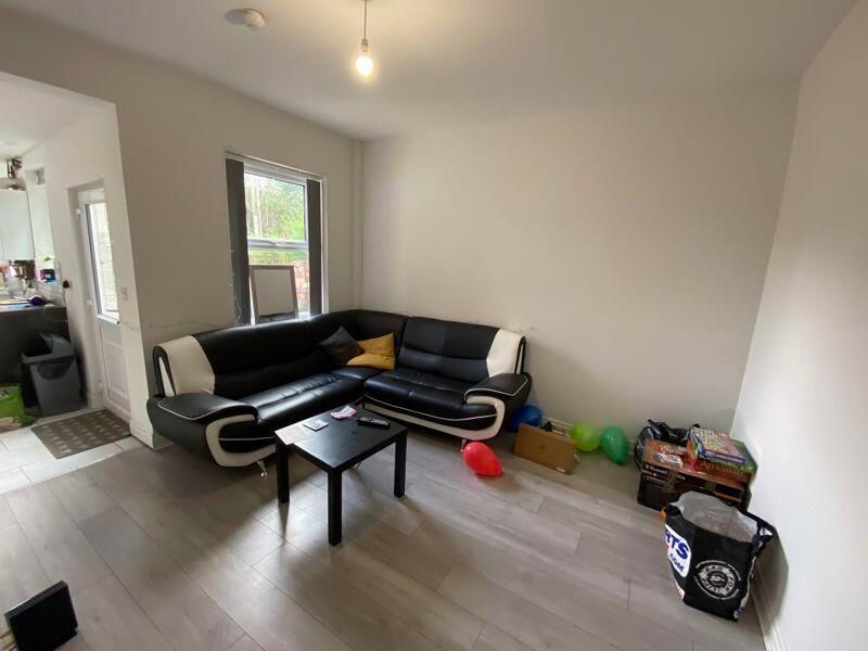 Property photo 1 of 14 A Modern And Inviting Living Room Featuring A Comf...