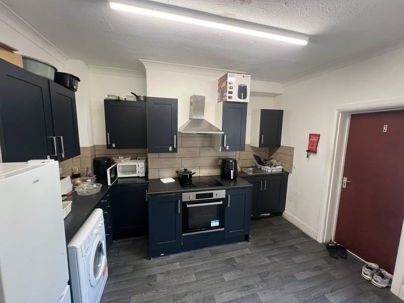 Property photo 3 of 6 Modern Kitchen With Stylish Navy Blue Cabinets...