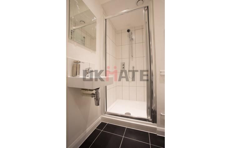 Property photo 2 of 11 A Modern, Clean Bathroom Featuring A Glass-Enclose...