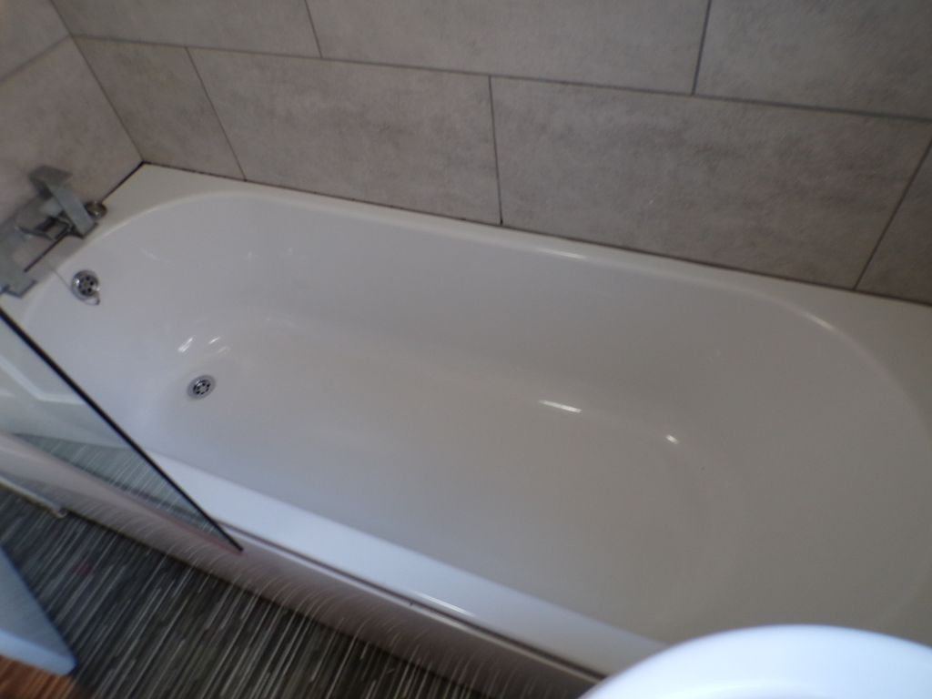 Property photo 2 of 9 A Modern Bathroom Featuring A Sleek Bathtub, Perfe...